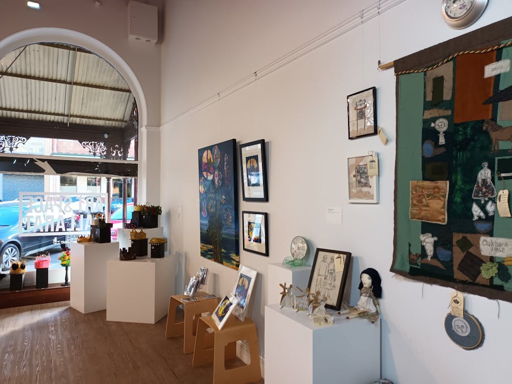 View from the back of Art Space looking towards the window with sculpture and 2D arts on the walls,