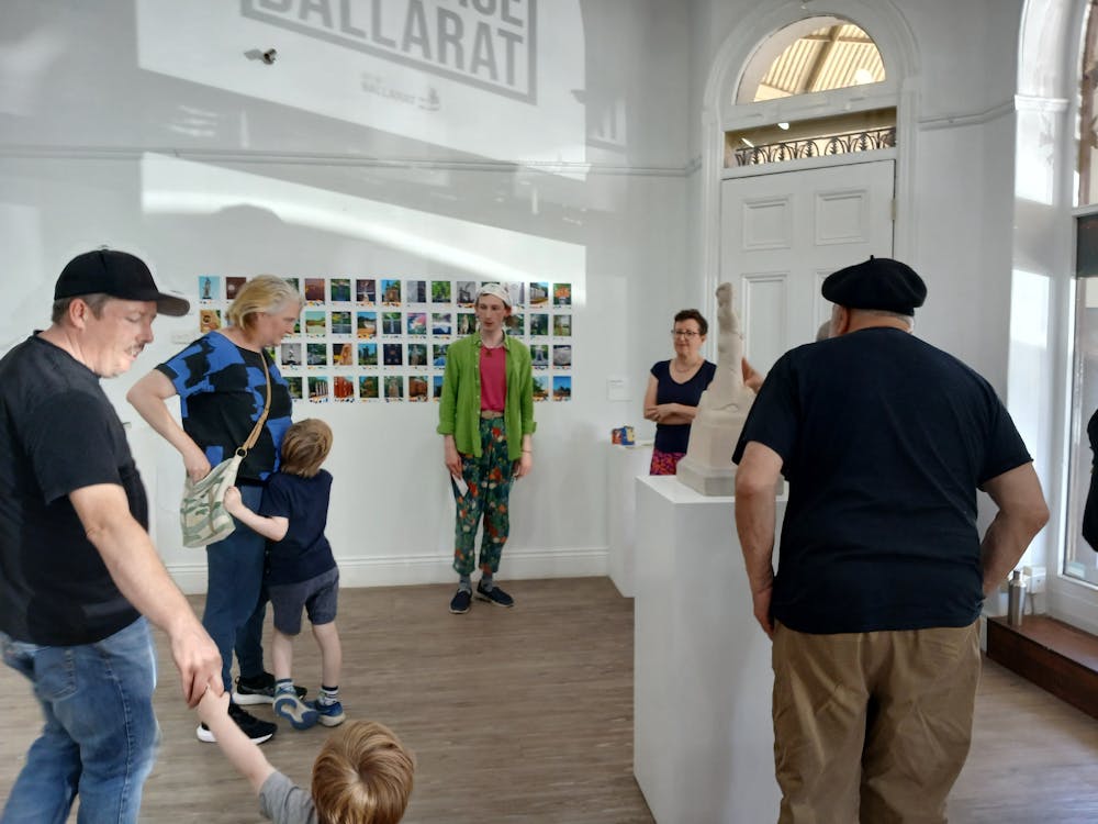 Members of the community viewing artworks installed in the gallery