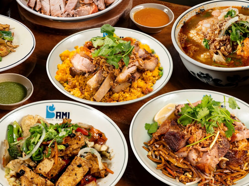 Bami Vietnamese food spread featuring crackling roast pork, smoky fried rice, Noodles and more