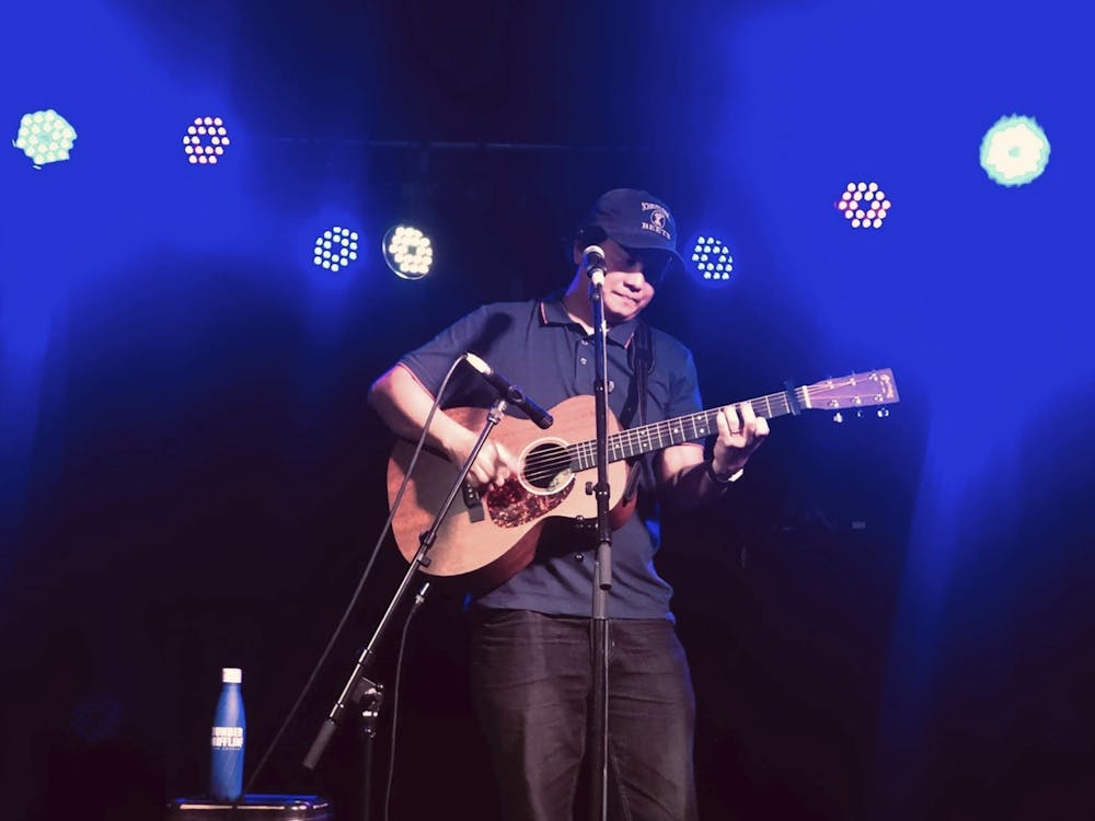Image shows Karlo Arcinue playing guitar