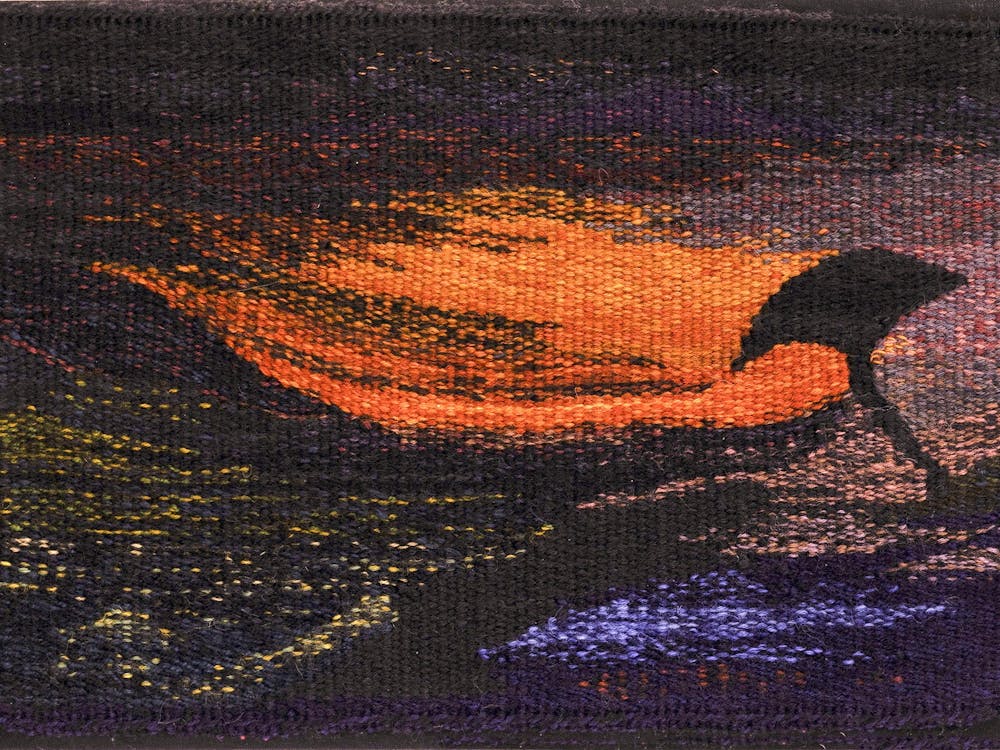 woven tapestry with reddsh golden scene