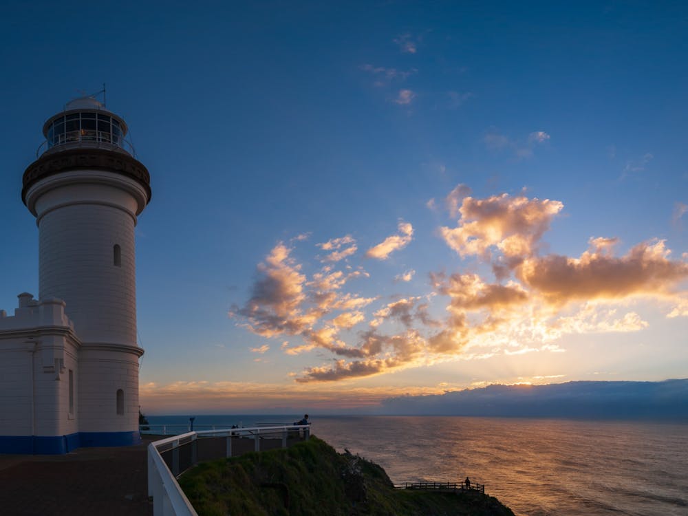 Golden Sunrise with clouds over the sea and lighthouse
