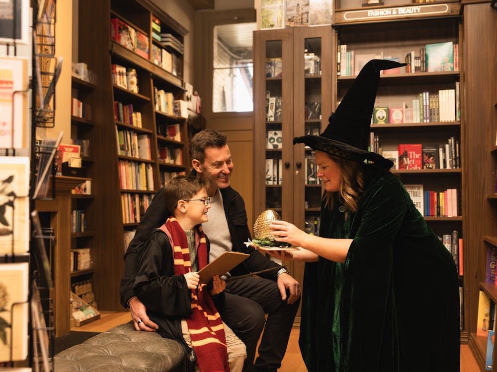 Father and son are entranced by Professor McGonagall showing them a dragon egg at Collins on Lydiard