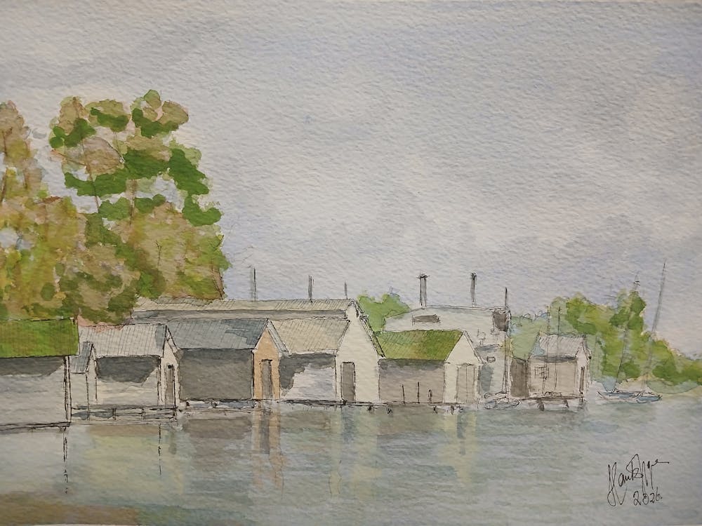 Tranquil scene of Lake Wendouree boatsheds on a calm day with reflections .