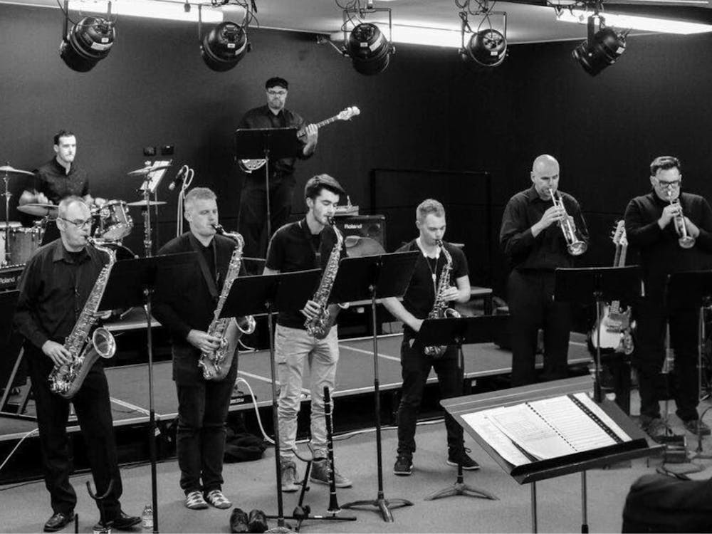 Members of Seb Big Band. People are playing trumpets, saxophones, bass, and drums.