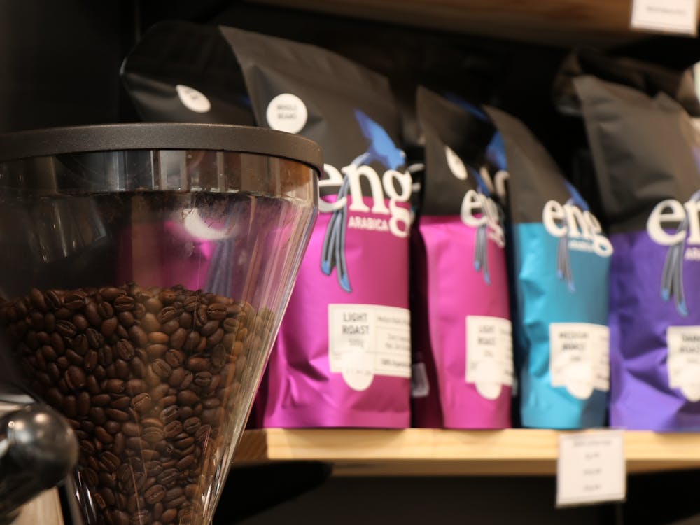 coffee beans in a machine next to packets of coffee beans