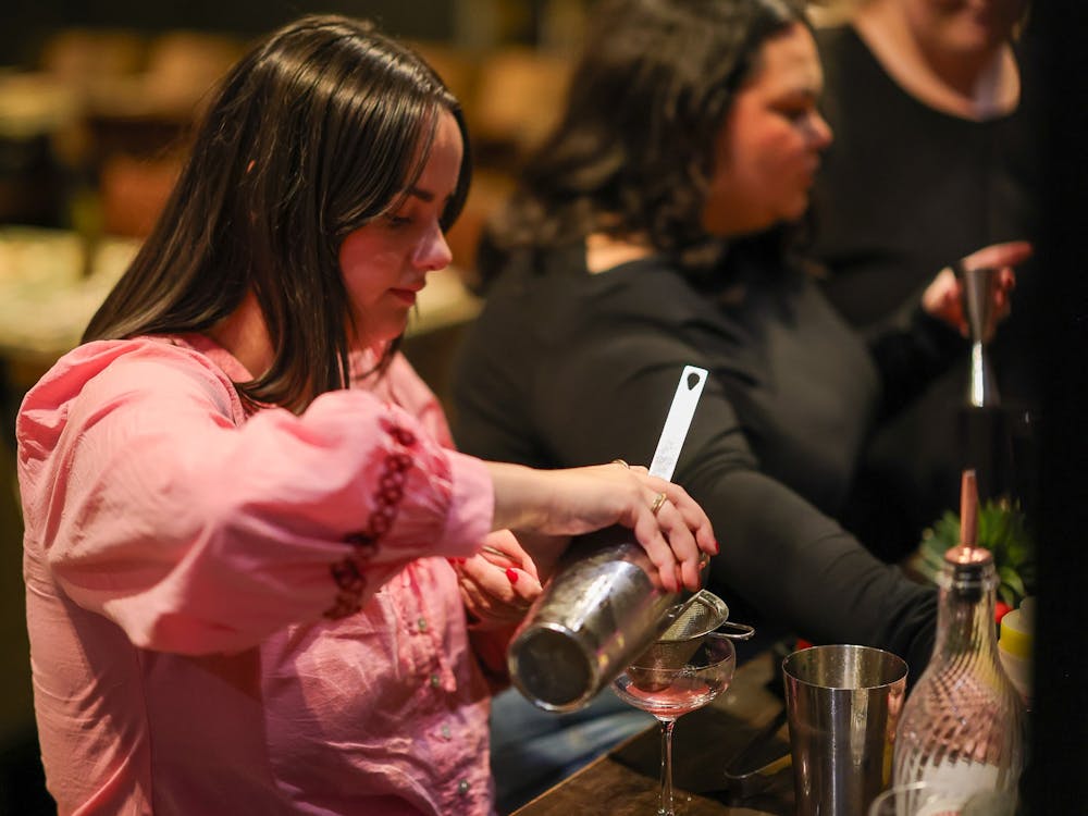 two women preparing a cocktail at Itinerant Spirits cocktail making class
