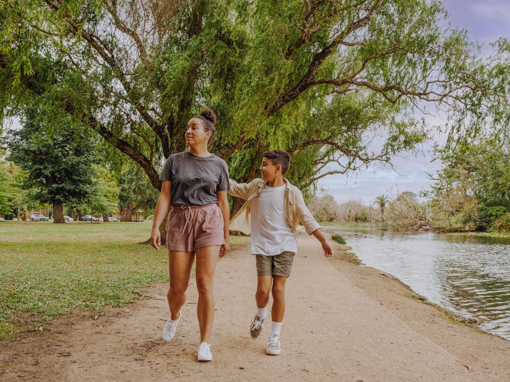 Adult women with child walking around Lake Wendouree pathway