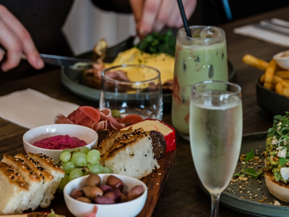 Shared brunch table with a grazing board, seasonal dishes and specialty drinks.
