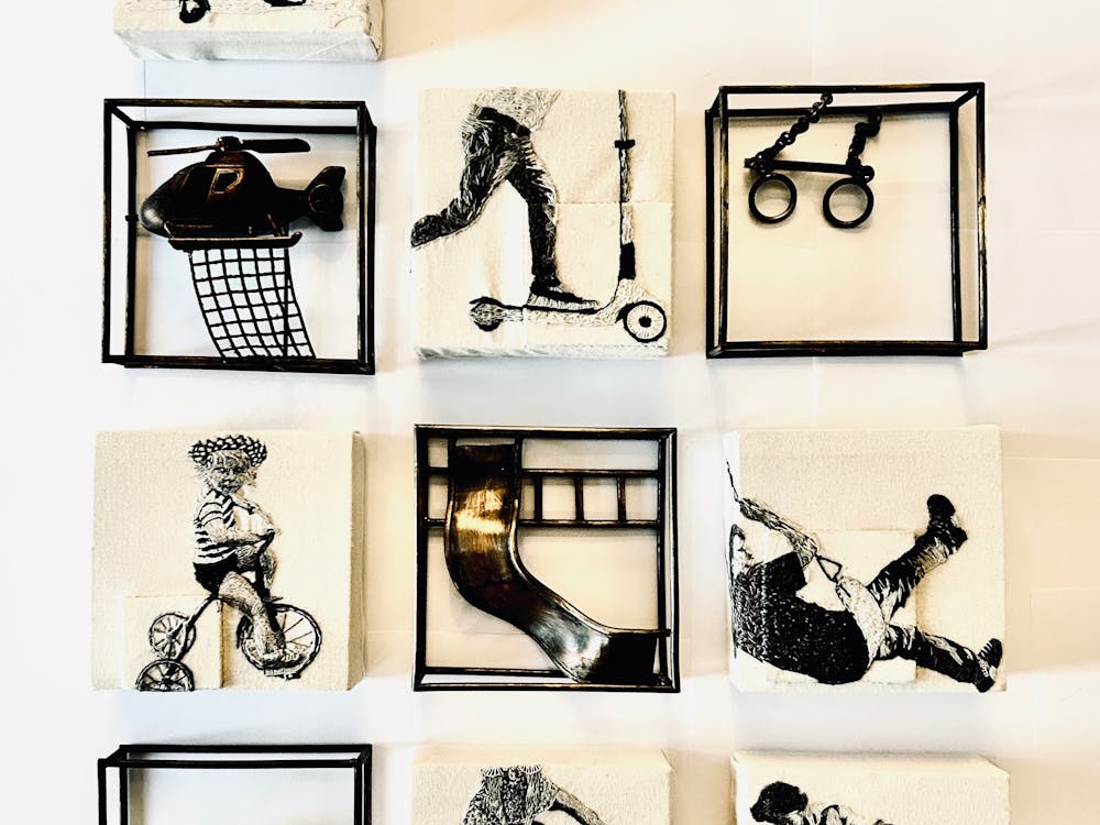 Squares with drawings, prints and 3D sculptures on them