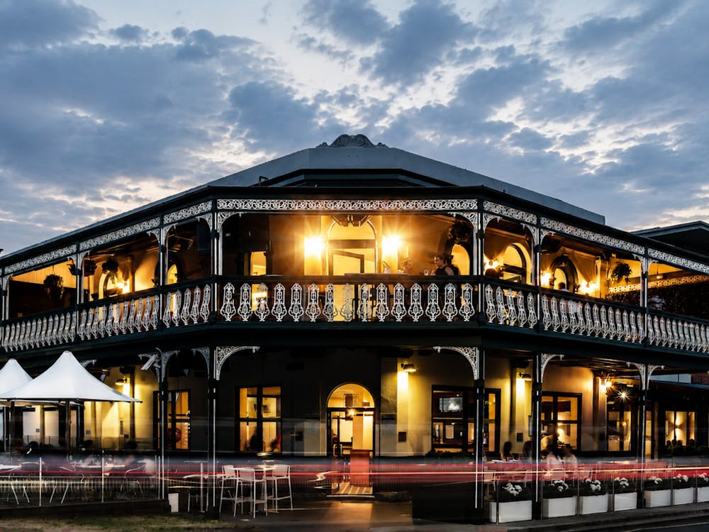 Exterior of The Lake View Hotel at dusk.