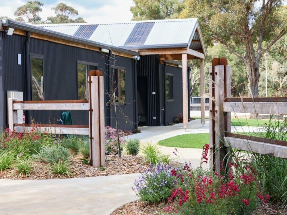Accommodation building with lovely gardens and lawn surrounding it