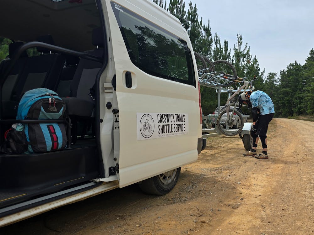van with open door and person with a bike