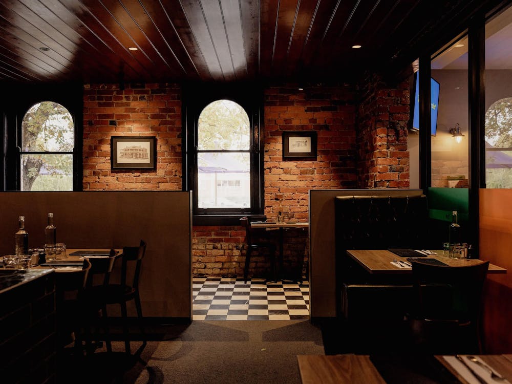 Dining booths inside The North Star Hotel with exposed brick walls and heritage windows.