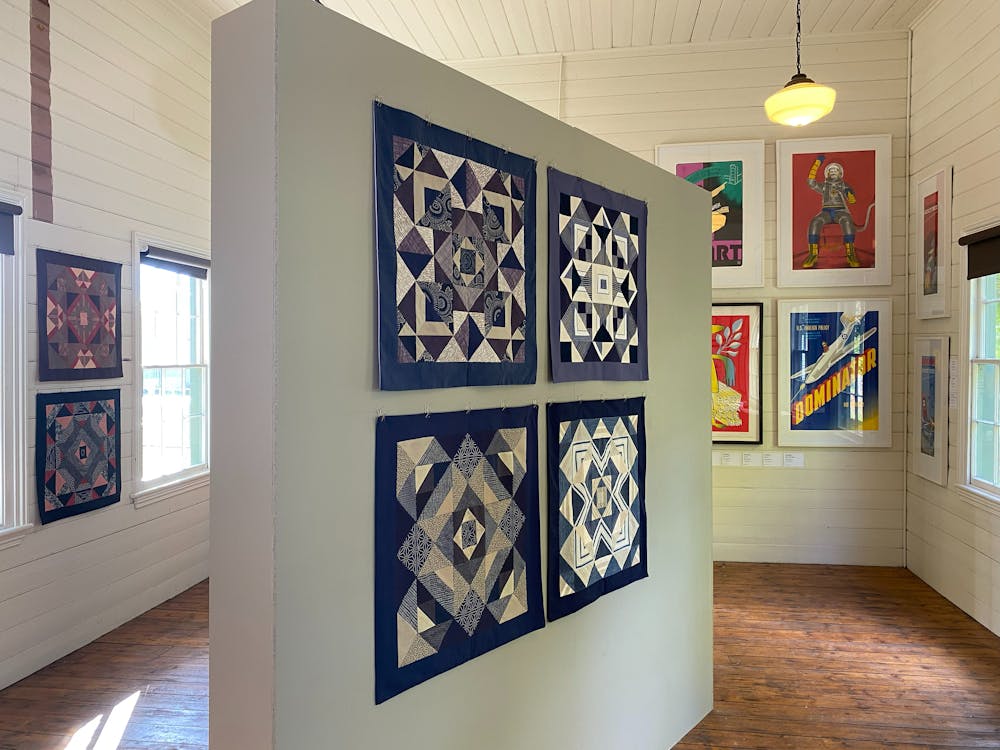 Gallery interior with artworks on freestanding wall, timber floors and shiplap walls, Clunes.