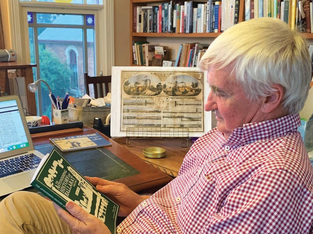 portrait of the speaker in his office reading a book