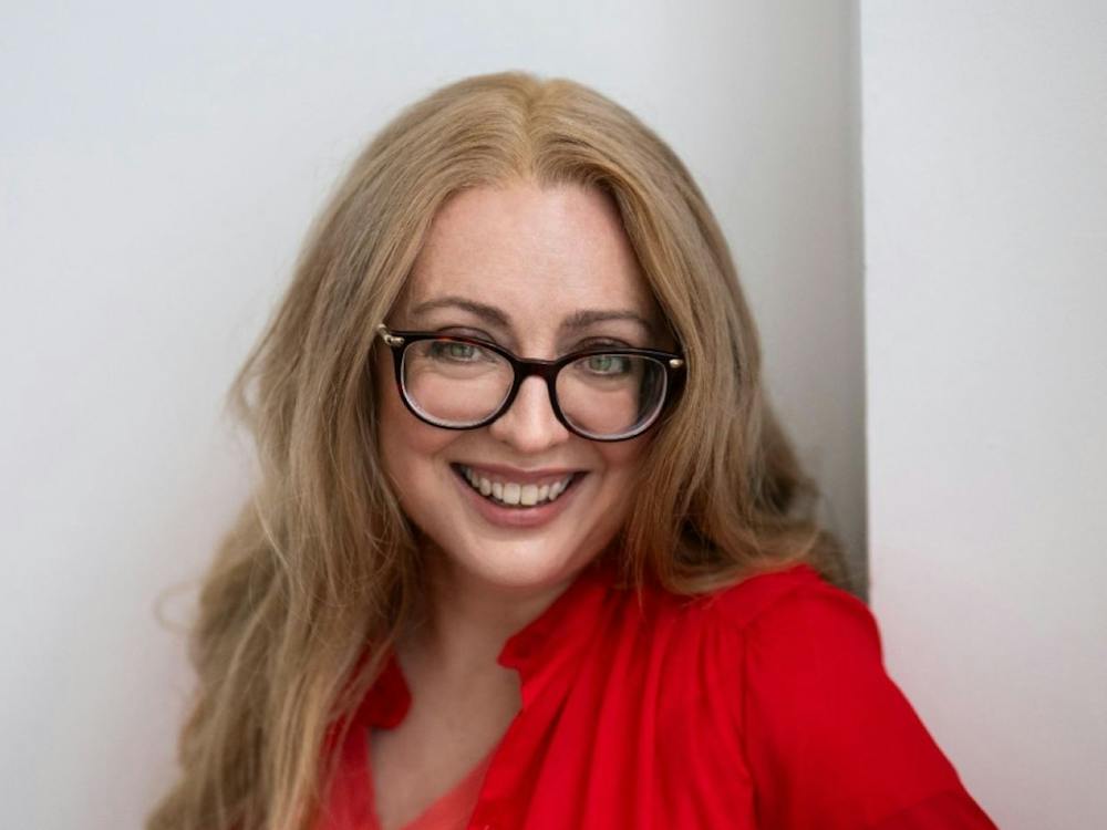 a lady facing the camera and smiling