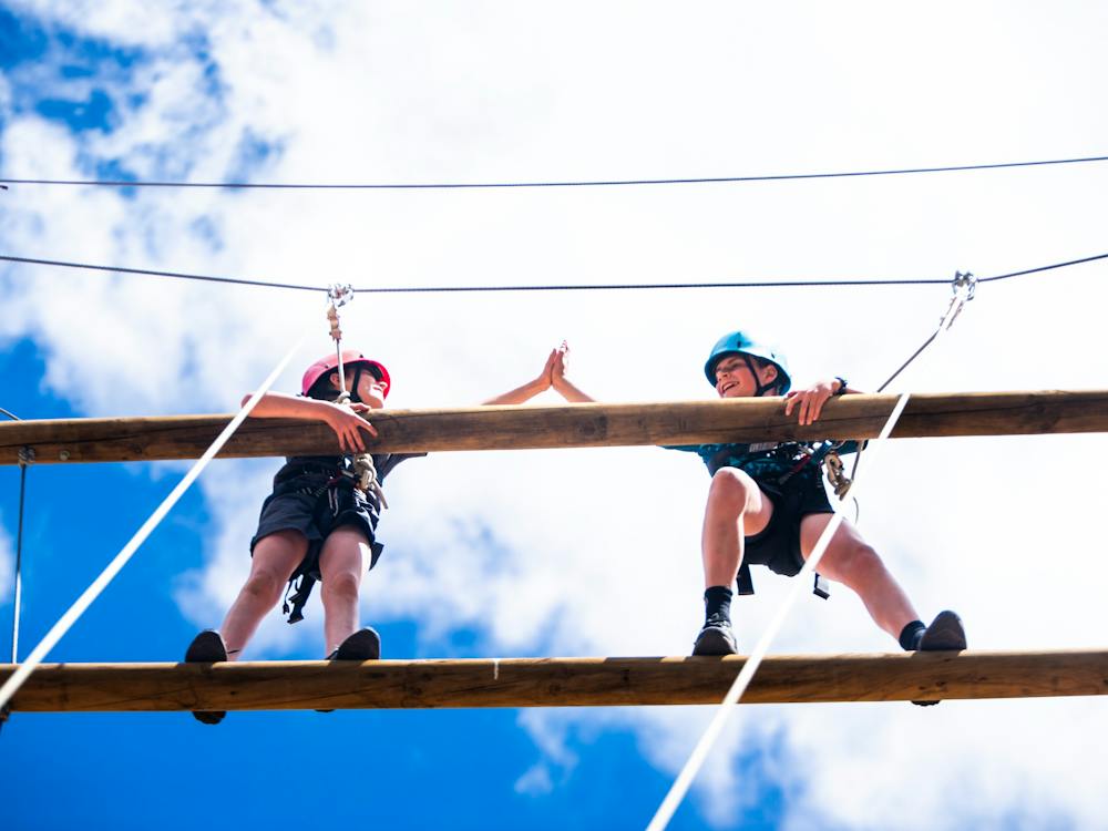 Two campers on giant ladder