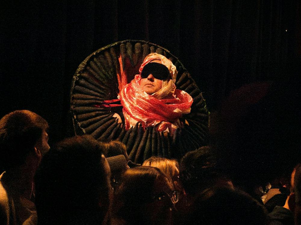 Artist in red and pink costume