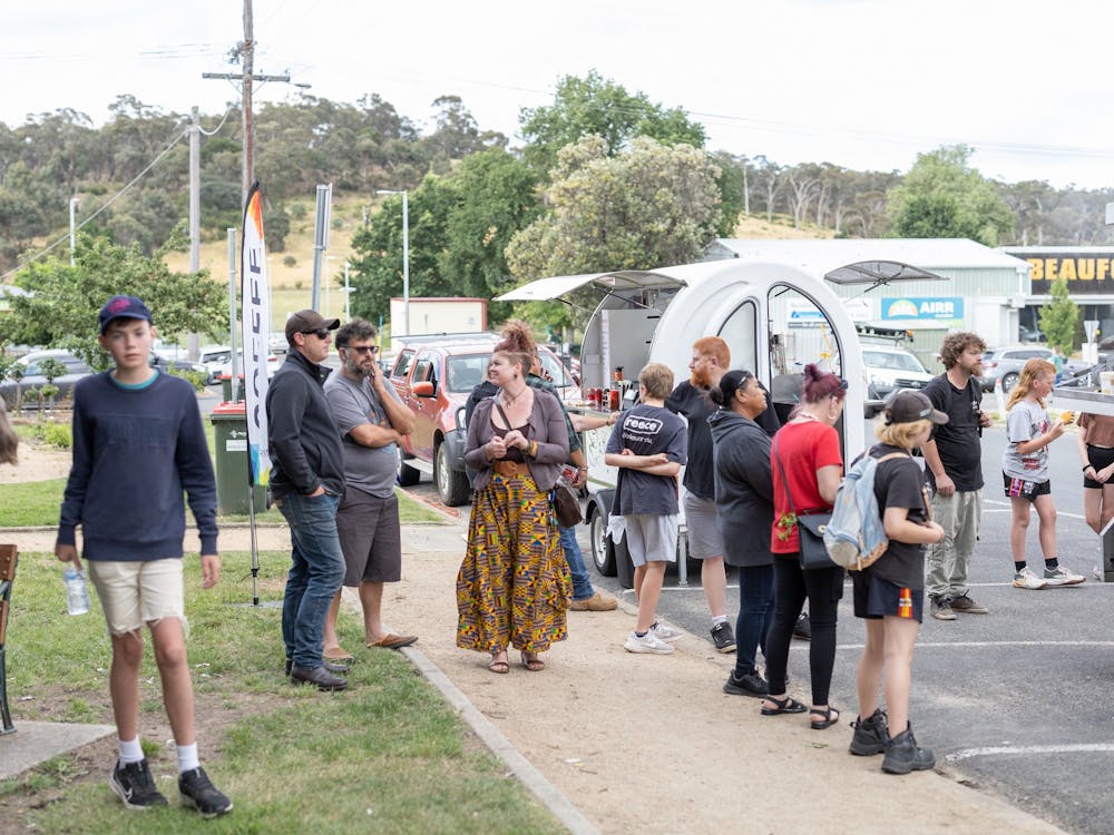 People gathered around the food trucks