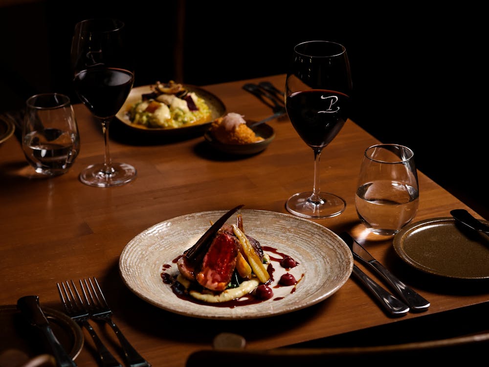 Dishes served with wine glasses at Peasant Osteria