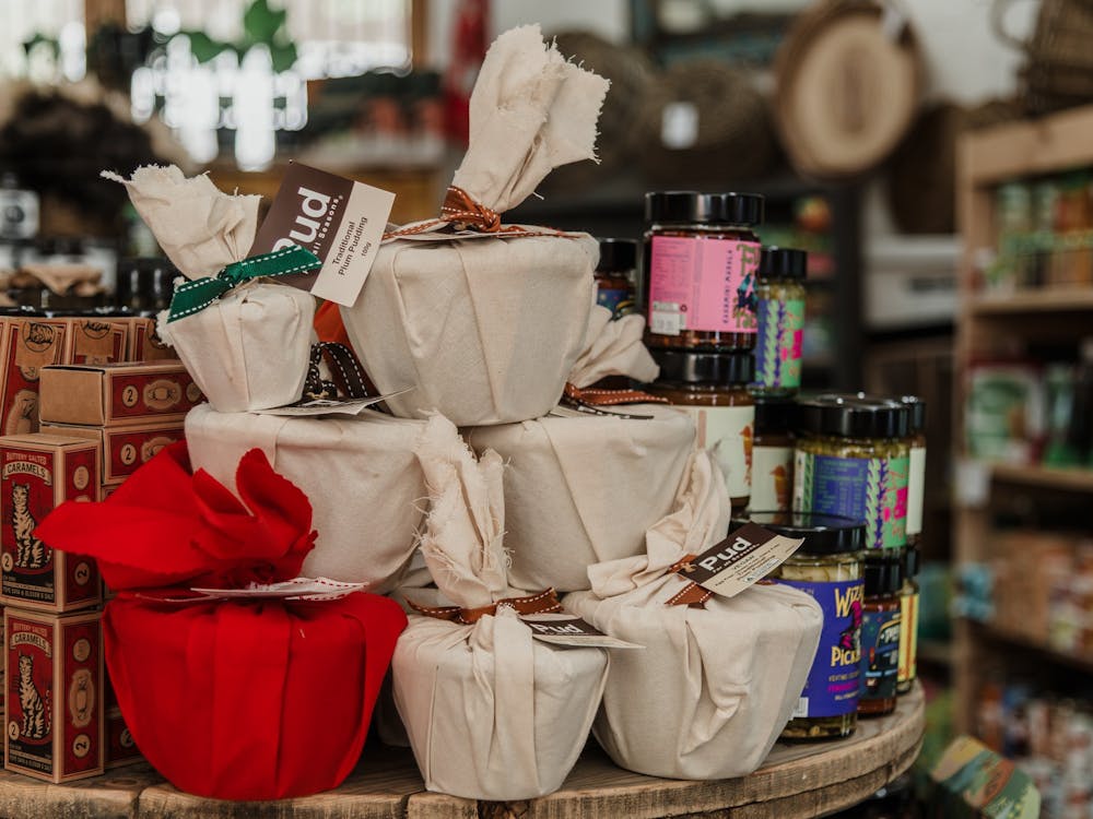 A stack of fabric-wrapped small Christmas puddings.
