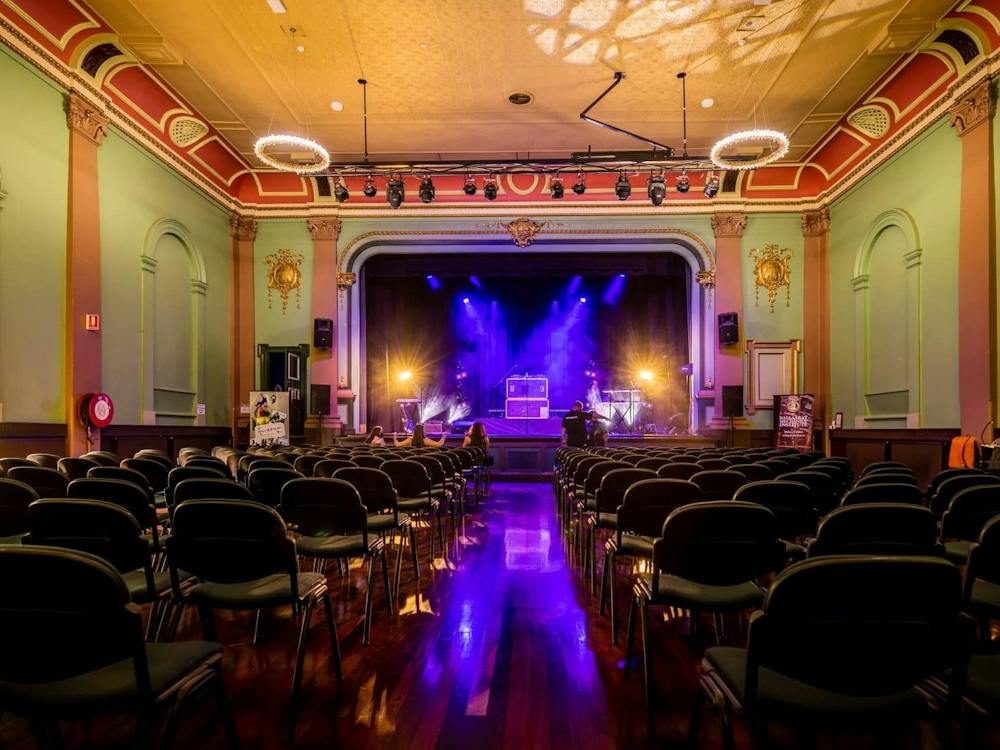 Interior of the Ballarat Mechanics Institute theatre, with rows of seating facing the stage.