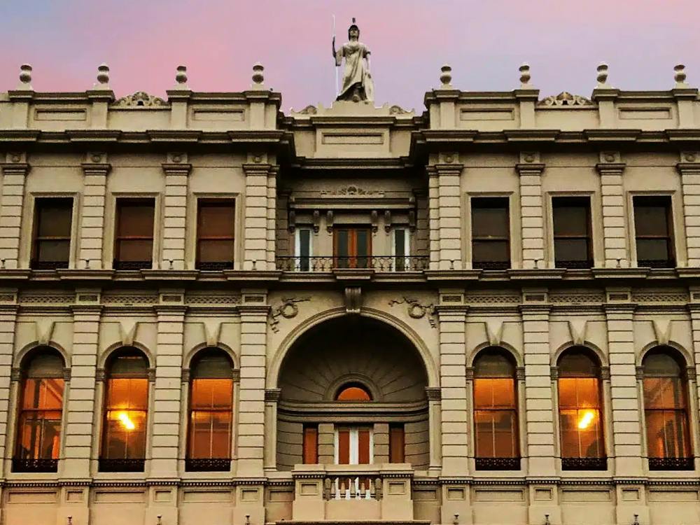 The historic façade of Ballarat Mechanics Institute in central Ballarat, lit warmly at dusk.