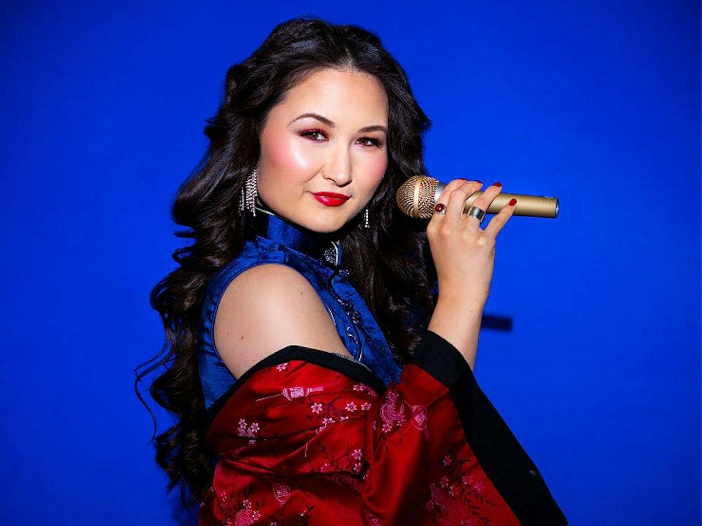 Portrait of artist with mic on a deep blue background